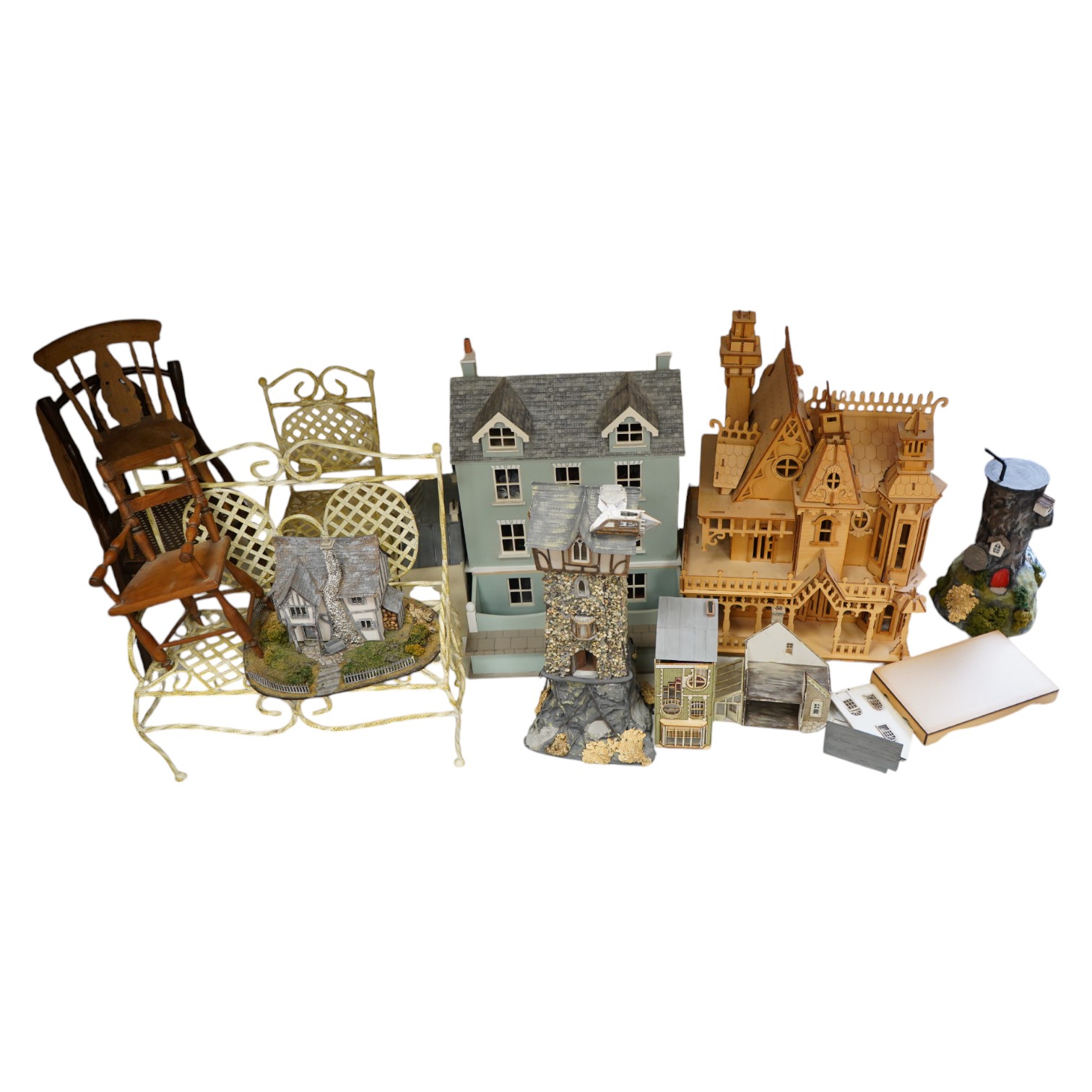 A modern plywood slot together model of a chateau, 50cm high, together with six miniature doll’s houses, a miniature wrought iron garden bench and chair set, and three miniature wooden chairs. Condition - fair.